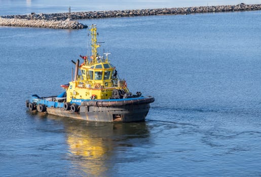 Montevideo, Uruguay - 5 February 2023: Tug Boat escorting cruise ship into port or harbor