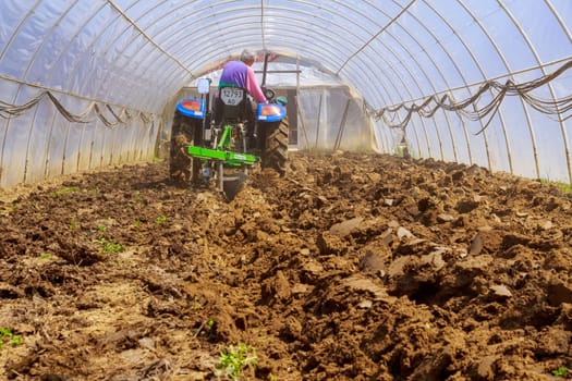 Uzhhorod, Ukraine, 10 May 2021: Land preparation for sowing or planting seedlings.