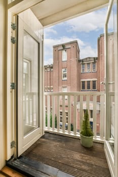 an outside area with a door, window and planter on the right hand side of the room looking out