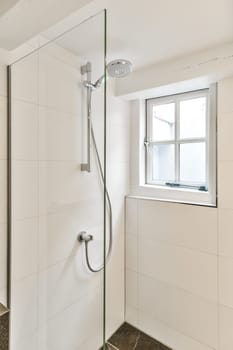 a bathroom with a shower and window in the back wall, which has been replaced to make it look more modern