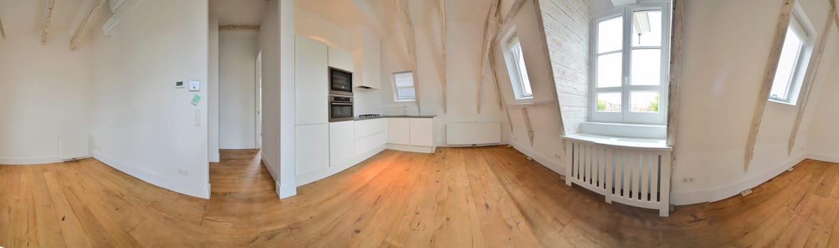 the inside of a room with wood flooring and an oven on the right side of the photo is taken