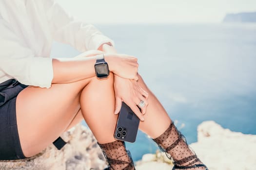 Happy girl doing yoga with laptop working at the beach. beautiful and calm business woman sitting with a laptop in a summer cafe in the lotus position meditating and relaxing. freelance girl remote work beach paradise