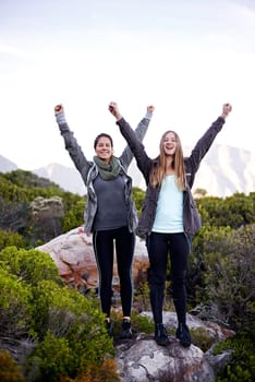 We made it. Portrait of two excited young female hikers in the outdoors