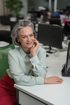 Mature caucasian woman at the desk in the office