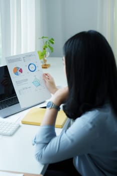 financial, Planning, Marketing and Accounting, portrait of Asian employee checking financial statements using documents and calculators at work..