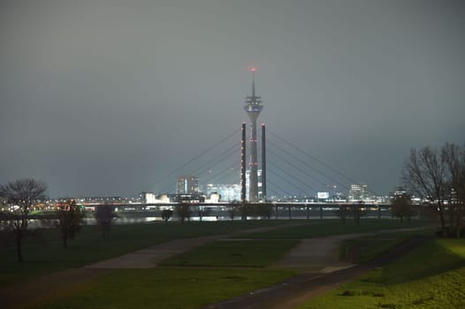 TV Tower and Theodor Heuss bridge at night and fog in Duesseldorf, Germany