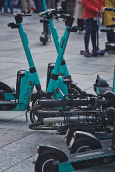 Vertical shot of a pile of e-scooters and e-bikes