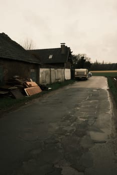 Caravan in front of run-down house on a side road near Meerbusch, Germany