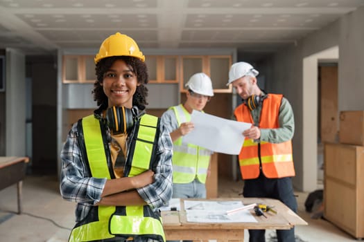 portrait female engineer project manager with construction gear and project blueprint Architecture team building plans.