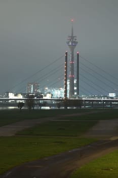 Tower and Theodor Heuss bridge at night and fog in Dusseldorf, Germany