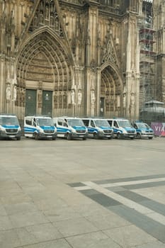 Row of Mercedes-Benz Sprinter police cars in front of Cologne Cathedral in Germany