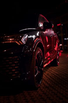 Light reflected in black SUV at night