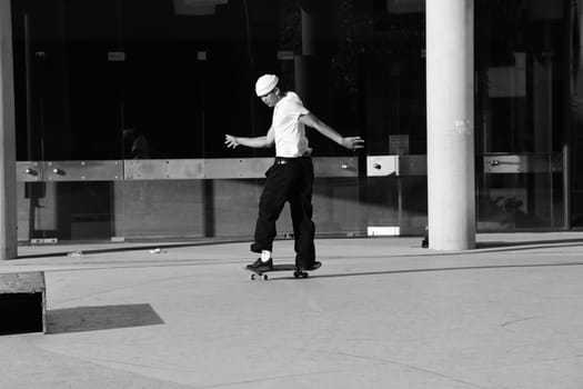 Skater in white shirt in front of the theater in Dusseldorf, Germany