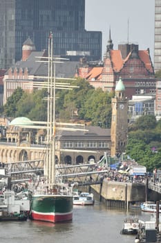 Scenic shot of harbour with an old ship and Hamburg architecture in Hamburg, Germany