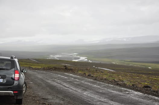 Gray SUV on a gravel road in Iceland
