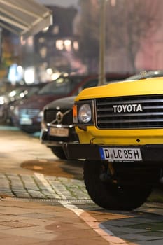 Front view with details of a parked old yellow Toyota Landcruiser in Duesseldorf, Germany