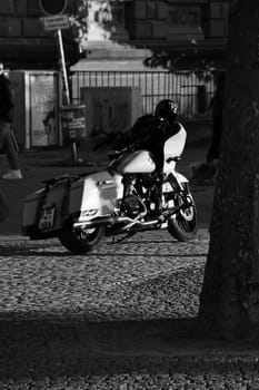 Vertical grayscale of a white chopper motorcycle. Harley Davidon in Duesseldorf, Germany.