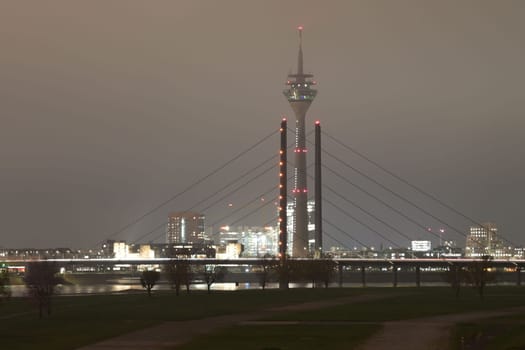 Tower and Theodor Heuss bridge at night and fog in Dusseldorf, Germany
