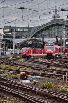 Red regional trains of the Deutsche Bahn at the main station in Cologne, Germany