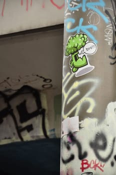 Vertical closeup shot of a graffiti and sticker on lanternon Tesnov Street in Prague, Czech Republic