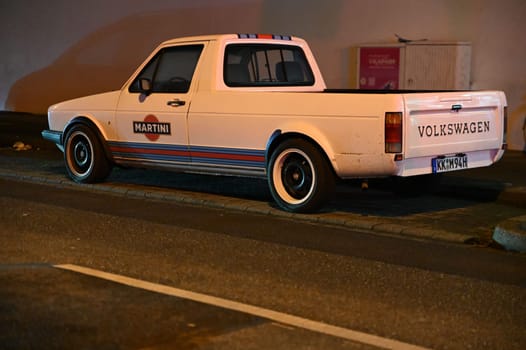 White, lowered Volkswagen Caddy with white wall tires on the roadside
