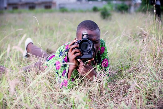 young tourist lying in the grass photography nature and landscape in the wild