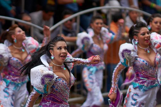 Oruro, Bolivia - February 26, 2017: Caporales dancers in ornate costumes performing as they parade through the mining city of Oruro on the Altiplano of Bolivia during the annual carnival.