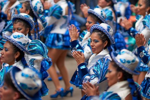 Oruro, Bolivia - February 26, 2017: Caporales dancers in ornate costumes performing as they parade through the mining city of Oruro on the Altiplano of Bolivia during the annual carnival.