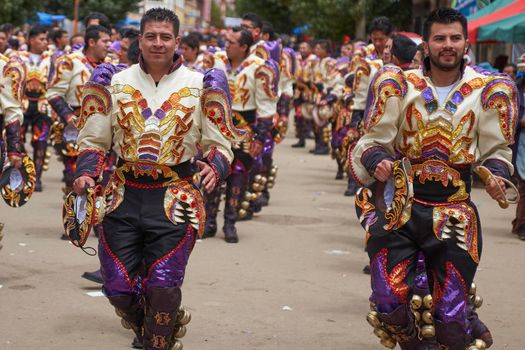 Oruro, Bolivia - February 26, 2017: Caporales dancers in ornate costumes performing as they parade through the mining city of Oruro on the Altiplano of Bolivia during the annual carnival.