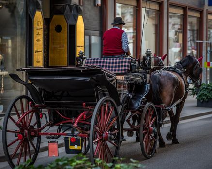 Horse-drawn carriage in old city, two horses carriage ride in Europe