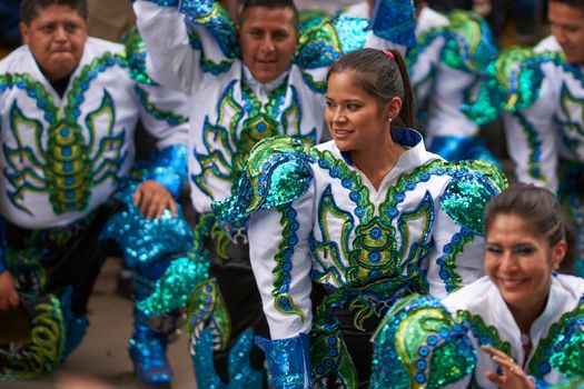 Oruro, Bolivia - February 26, 2017: Caporales dancers in ornate costumes performing as they parade through the mining city of Oruro on the Altiplano of Bolivia during the annual carnival.