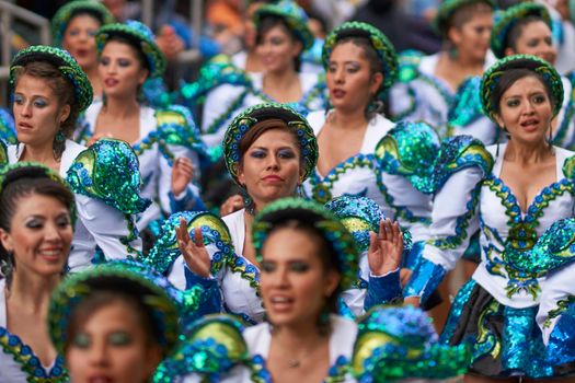 Oruro, Bolivia - February 26, 2017: Caporales dancers in ornate costumes performing as they parade through the mining city of Oruro on the Altiplano of Bolivia during the annual carnival.