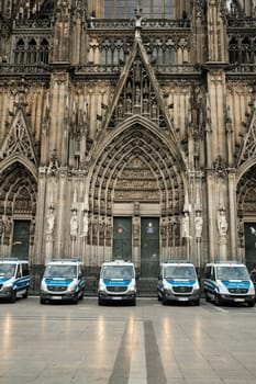 Row of Mercedes-Benz Sprinter police cars in front of Cologne Cathedral in Germany
