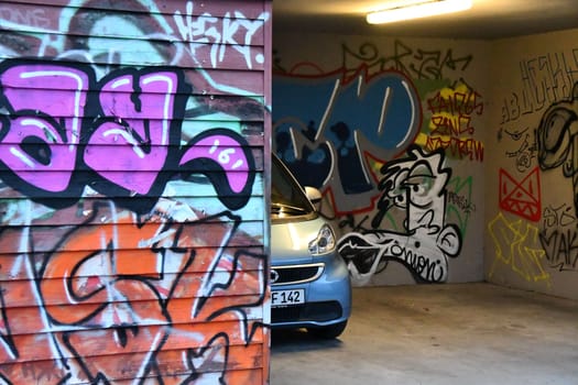 Smart Fortwo standing in a carport covered in graffiti