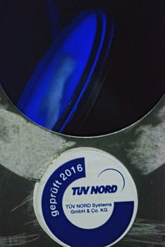 Vertical closeup of a broken escalator column with TUEV Nord test seal on the A40 in Essen, Germany