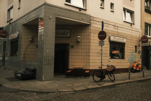 Pub on a German street with street signs and a bike parked near the signs in Hamburg, Germany