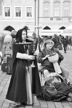 Grayscale of Medieval musicians on the square of Prague, Czech Republic