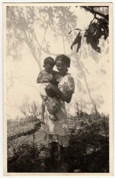 THE CZECHOSLOVAK SOCIALIST REPUBLIC - CIRCA 1950: Vintage photo shows happy mum with child.