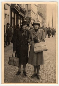 PRAGUE, THE CZECHOSLOVAK REPUBLIC - NOVEMBER, 1947: Vintage photo shows women go along the street.