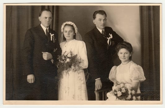 PRIBRAM, THE CZECHOSLOVAK REPUBLIC - FEBRUARY 22, 1941: Vintage photo of newlyweds (two couples)