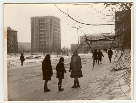 USSR - CIRCA 1980s: Vintage photo shows girls and boy talk on street in winter.