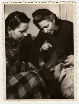 USSR - CIRCA 1980s: Vintage photo shows women, one of them strokes dog.