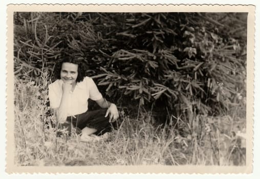 USSR - CIRCA 1960s: Vintage photo shows woman sits outdoors.