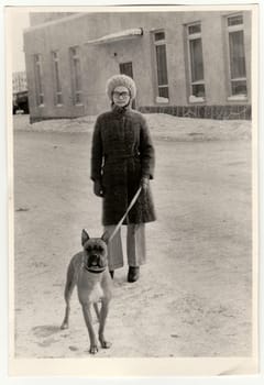 USSR - CIRCA 1970s: Vintage photo shows woman walks the dog.