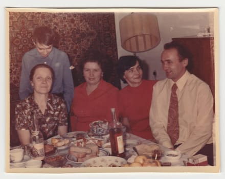 USSR - CIRCA 1970s: Vintage photo shows family during feast.