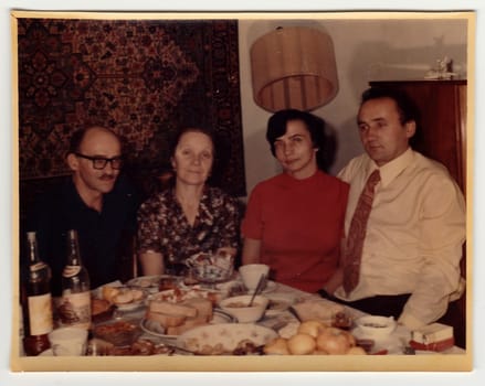 USSR - CIRCA 1970s: Vintage photo shows family during feast.