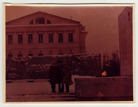 USSR - CIRCA 1970s: Vintage photo shows people pose on the street in winter. Photo is under exposed.