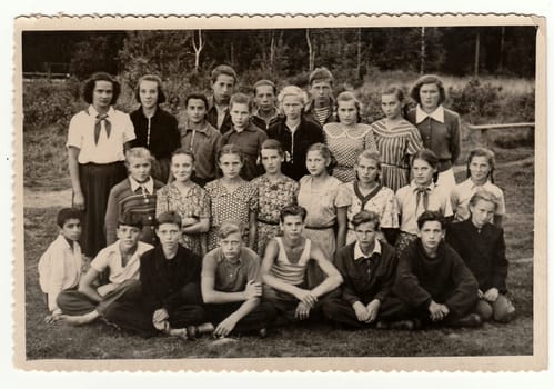 USSR - CIRCA 1950s: Vintage photo shows teenagers and female chiefs at summer camp.
