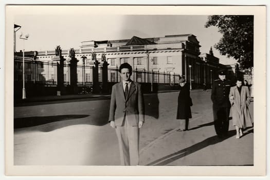 USSR - FEBRUARY 29, 1952: Vintage photo shows a young man poses on the street. Black & white retro photo.