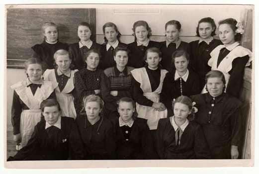 USSR - CIRCA 1950S: Vintage photo shows schoolmates (girls) and their female teacher.